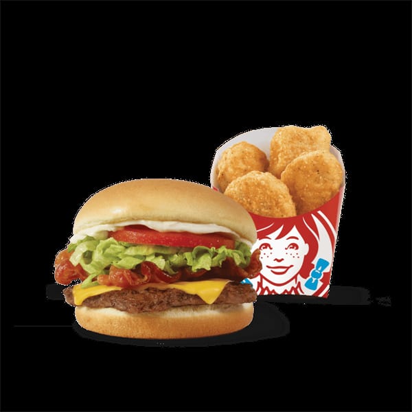 Wendy's cheeseburger with bacon, lettuce, tomato, and mayonnaise, next to a box of chicken nuggets.