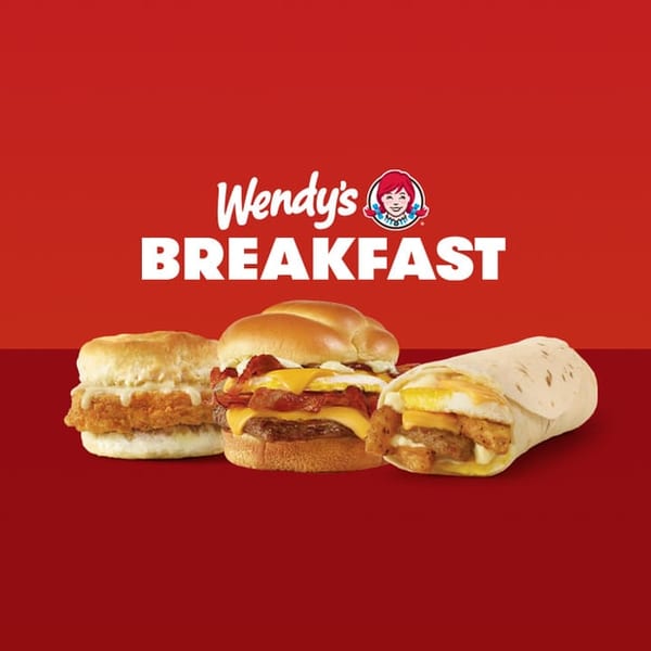 Wendy's breakfast items: a chicken biscuit, a breakfast burger, and a breakfast burrito.